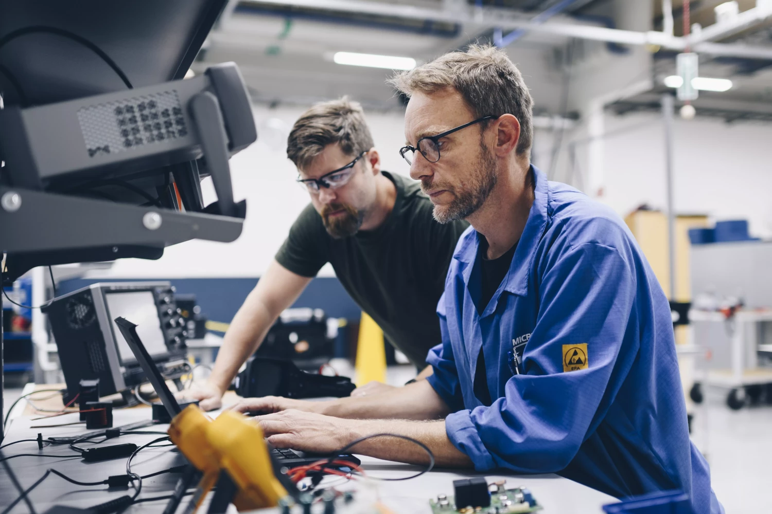 Engineers working with electrical systems to optimize battery performance and battery balancing in industrial OEM vehicles