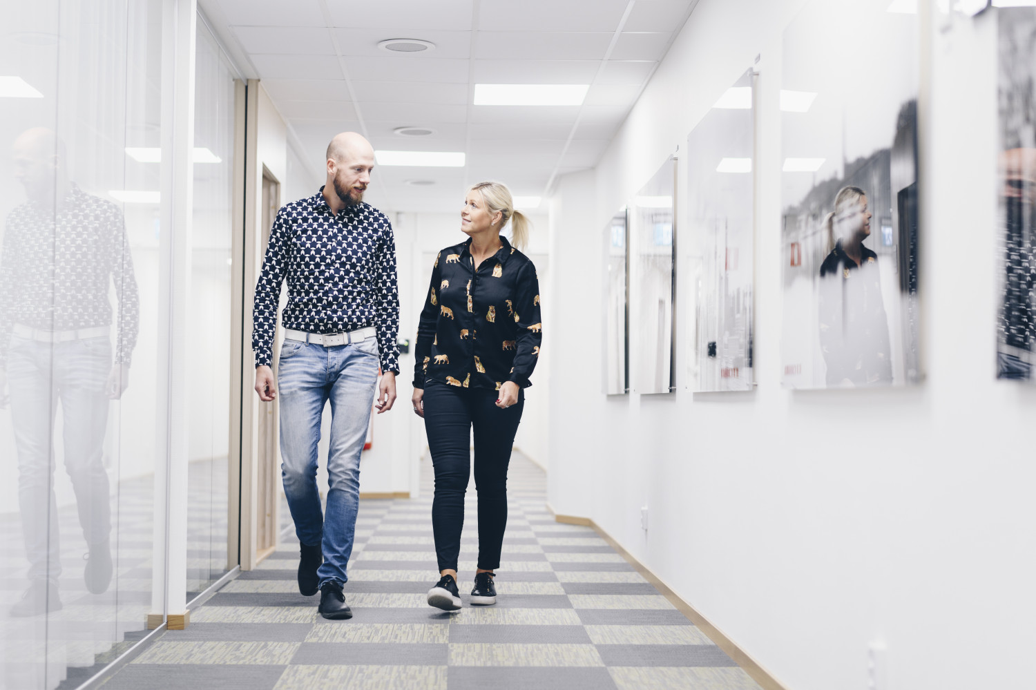 Two employees walk together in a corridor at Micropower