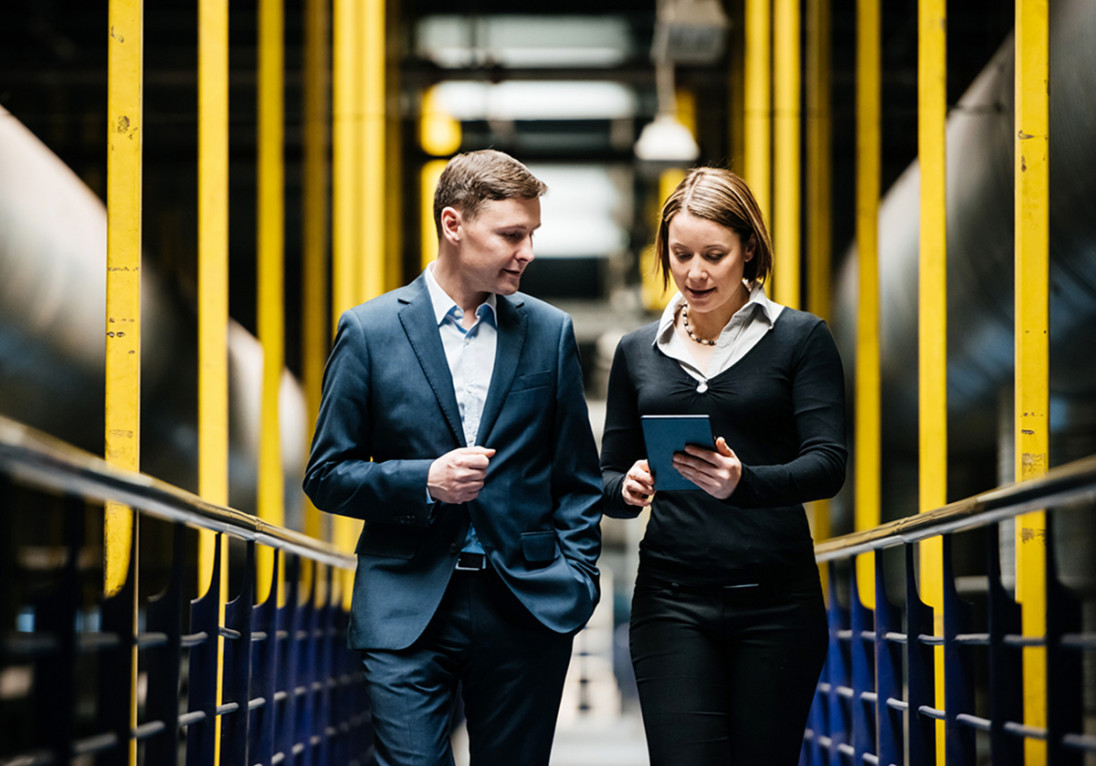 Two employees at micropower discuss in the factory